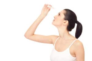Woman putting eye drops into her eyes, dry eye, dry eye care, eye care Springfield MA, dry eye doctor Western MA, eye doctor Western MA, Dr. Papale eye doctor