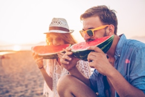 two people eating watermelon on the beach, healthy eye tips, eye exam Western MA, eye doctor Springfield MA