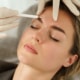 Doctor making marks on client's face before filler injections at Optometrist office