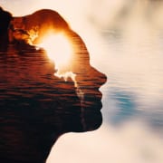 Sun peeks out from behind the clouds in woman's head